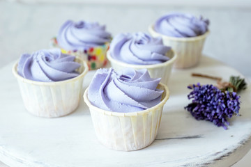 Lavender cupcakes. Desserts for birthday, weddings, holidays. Sweet purple background.