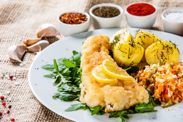 Fish dish - fried fish fillet boiled potatoes and vegetables