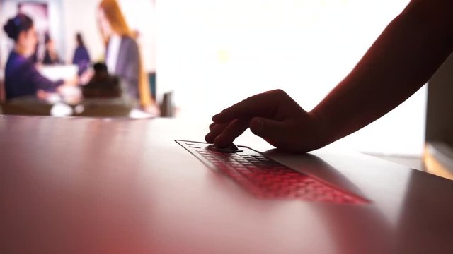 Close up hand use trackball keyboard.