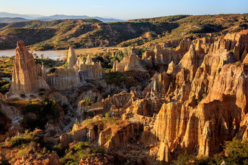 Earth Forest of Yuanmou in Yunnan Province, China - Exotic earth and sandstone formations glowing in the sunlight. Naturally formed pillars of rock and clay with unique erosion patterns. China Travel