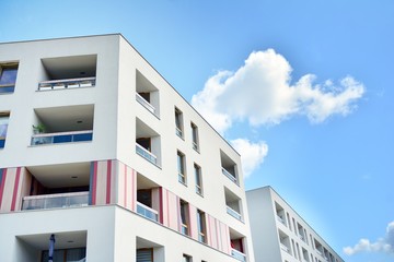 modern apartment building with blue sky and clouds