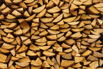 Firewood stacked. Chipped firewood.  Preparation to winter season. Background