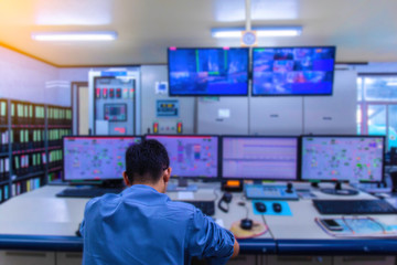 Double exposure Blurred light of man Engineering operations checking production process, Control room of a steam Turbine, Generators in the coal-fired power plant. Technology and industry concept