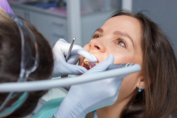 Examination oral cavity or treatment teeth, visiting dental office, blurred background