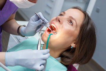Examination oral cavity or treatment teeth, visiting dental office, blurred background