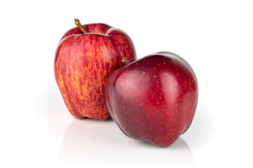 Group of two whole fresh apple red delicious one in front of the other isolated on white background