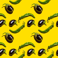 seamless pattern of hot chili peppers and dark purple eggplants