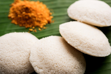 Podi idli is a quick and easy snack made with leftover idly. served with sambar and coconut chutney. selective focus