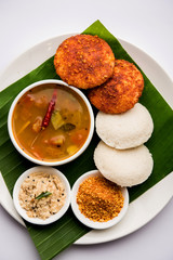 Podi idli is a quick and easy snack made with leftover idly. served with sambar and coconut chutney. selective focus
