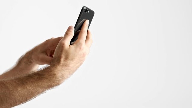 Cropped view of man taking selfie while using smartphone over white background isolated
