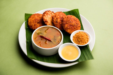 Podi idli is a quick and easy snack made with leftover idly. served with sambar and coconut chutney. selective focus