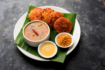 Podi idli is a quick and easy snack made with leftover idly. served with sambar and coconut chutney. selective focus