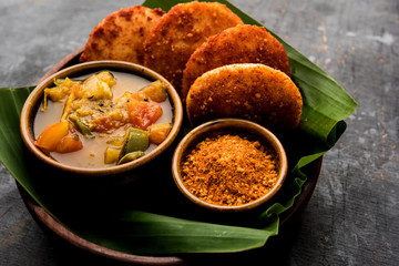 Podi idli is a quick and easy snack made with leftover idly. served with sambar and coconut chutney. selective focus