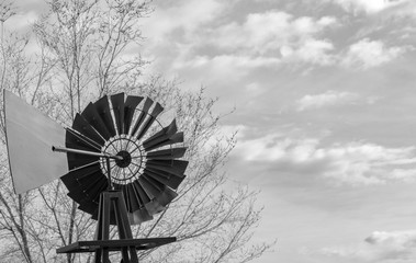 Southwestern windmill with clouds and sky in background