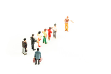 Miniature People Standing in a Line, Waiting