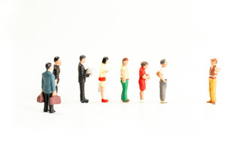 Miniature People Standing in a Line, Waiting