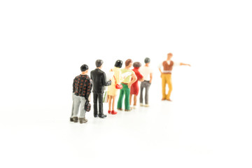 Fototapeta na wymiar Miniature People Standing in a Line, Waiting