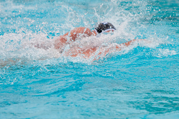 Athletes swimming freestyle on a swimming pool