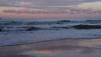 Fototapeta na wymiar beautiful sunset beach with dramatic clouds and sky background