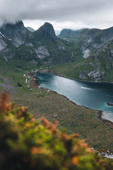 a boat in the fjord with mountains