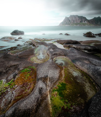 rocks coast with mountain in the background