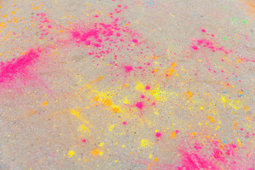 Holi colors scattered on asphalt after Holi festival