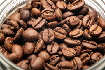roasted coffee beans in a glass jar