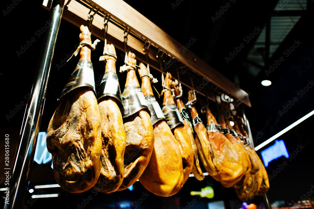 Wall mural Traditional spanish jamon ham for sale at supermarket.