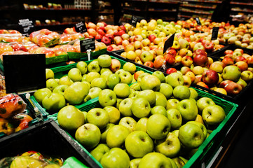 Fresh apples at boxes on supermarket.