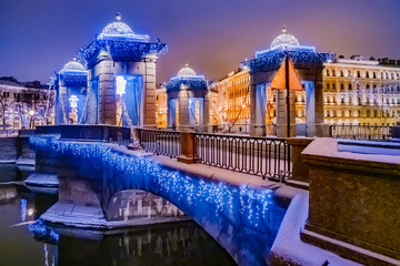 Saint-Petersburg. Russia. Bridges Of St. Petersburg. The Canals Of St. Petersburg. New year. Christmas. Lomonosov Bridge. The Fontanka River. The bridge is decorated with garlands.