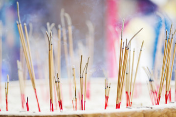 Incense sticks burning in old pot in the temple