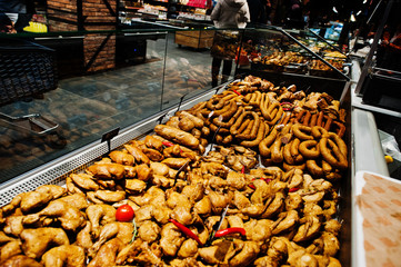 Various meat on supermarket shelves for sale.