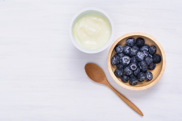 Yoghurt eating with blueberry fruit on white background, healthy food