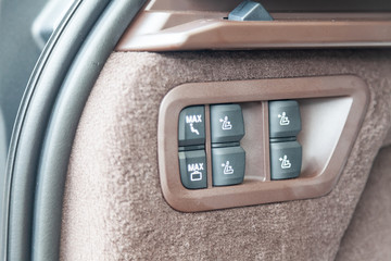 View to the white and brown interior of car with dashboard of adjust rear seats buttons after cleaning before sale on parking