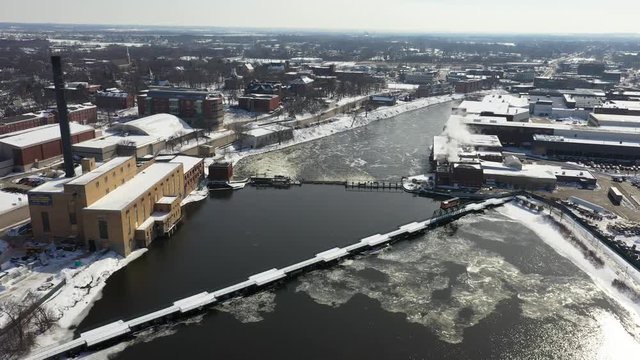 Fordham Dam and Rockford Illinois city covered in winter snow, aerial view