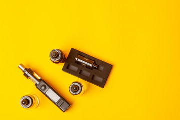 Vape. Vape devices on a yellow background. E-cigarette. Smoking vape. Electronic Cigarette.