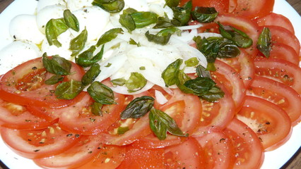 Sliced tomato with buffalo mozzarella onions and olive oil