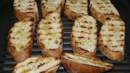 Toasted bread slices with olive oil in the riffel pan