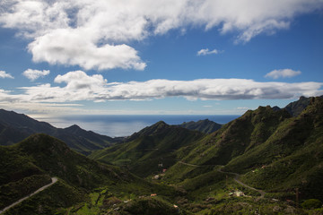 View of winding road go through green hills to atlantic ocean. Beautiful mountains on the Sao Miguel island, Azores