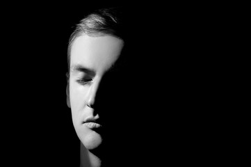 black and white photo, large portrait half face lit