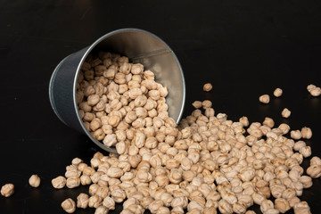 Chickpeas in the metal bucket on the table