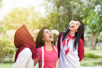 Fototapeta premium portrait of indonesia crackers eating competition on independence day celebration