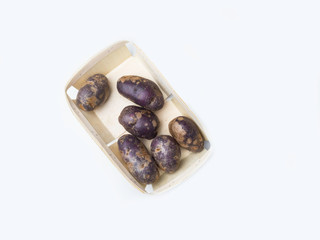Freshly harvested organic sweet potatoes in wooden box. Sweet potato contain insoluble fiber that can help relieve constipation.