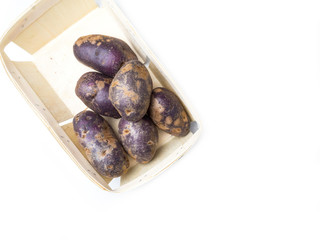 Freshly harvested organic sweet potatoes in wooden box. Sweet potato contain insoluble fiber that can help relieve constipation.