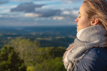 Christian worship and praise. A young woman is praying and worshiping in the evening.