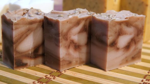 The concept of eco body care products. Colored decorative souvenir soap in assortment. Collection of decorative soaps for different needs in store display. Soap making, creativity.
