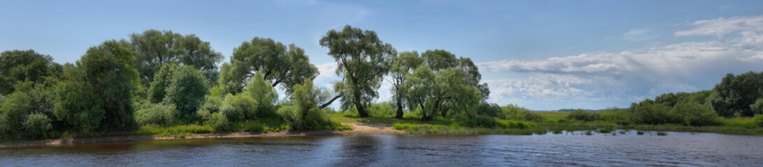 Large-format summer panorama with a river and a picturesque shore