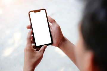 Obraz na płótnie Canvas Mock up smartphone of hand holding black mobile phone with blank white screen