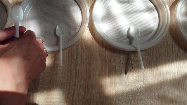 Disposable plastic tableware. Plastic dishes on the table.