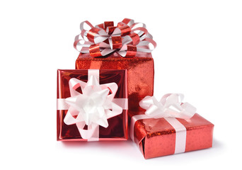 Red gift box and ribbon bow on white background. Concept for Valentine day, Christmas present and New Year.